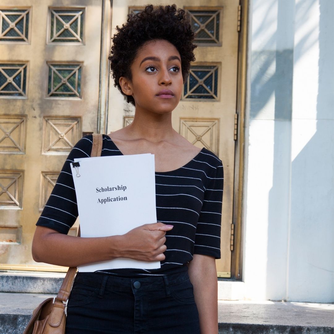 girl holding her scholarship application