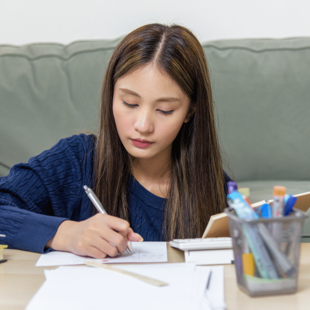 Student writing Letter of Continued Interest at desk