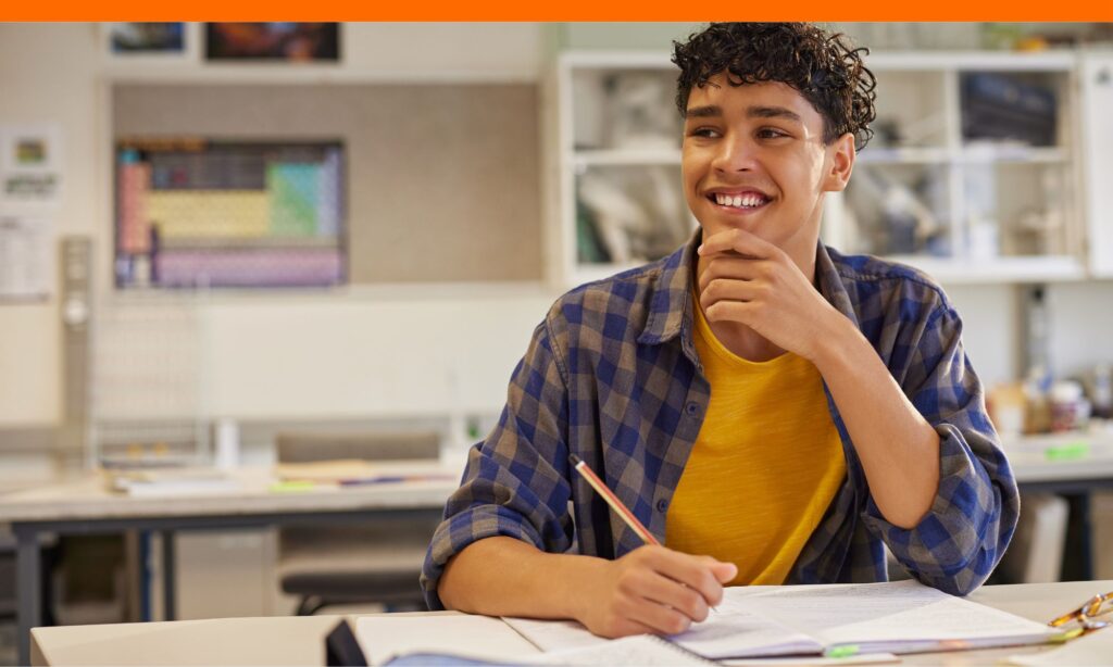 Teen boy drafting a letter with LOCI examples on laptop