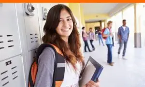 teen girl leaning on locker happy for scholarship north dakota