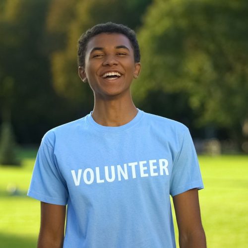 boy student wearing a volunteer t shirt