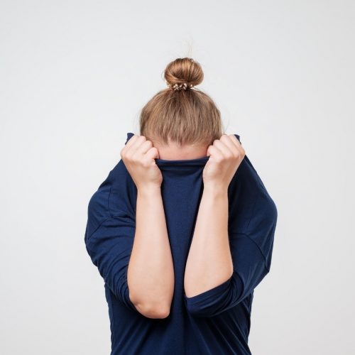 girl covering her face with her blouse