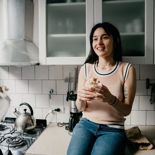 girl having a snack in the kitchen