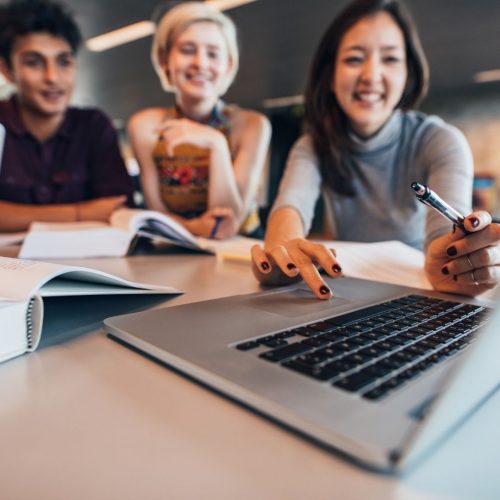 3 students laughing and studying