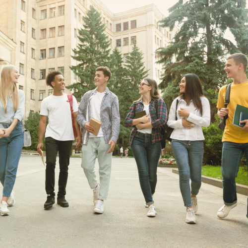 Group of college students walking together on campus, illustrating trends in college deferral statistics and how students deferred from college navigate decisions influenced by college deferral rates and deferral acceptance rates for college deferral 2025.