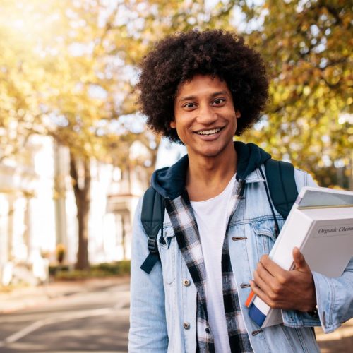 Colleges with Rolling Admissions man holding a books