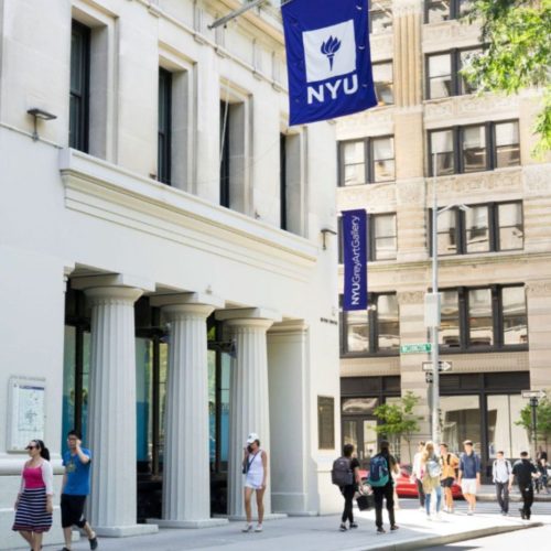 Scholarships to NYU people walking in a building