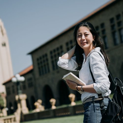 Scholarships to NYU girl holding a book