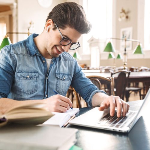 Scholarships to NYU man reading on a computer