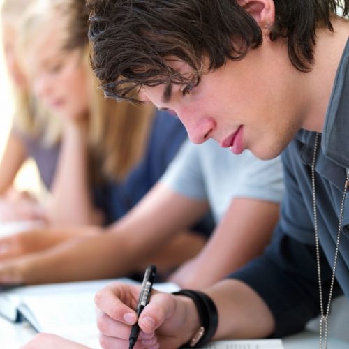 boy writing in notebook