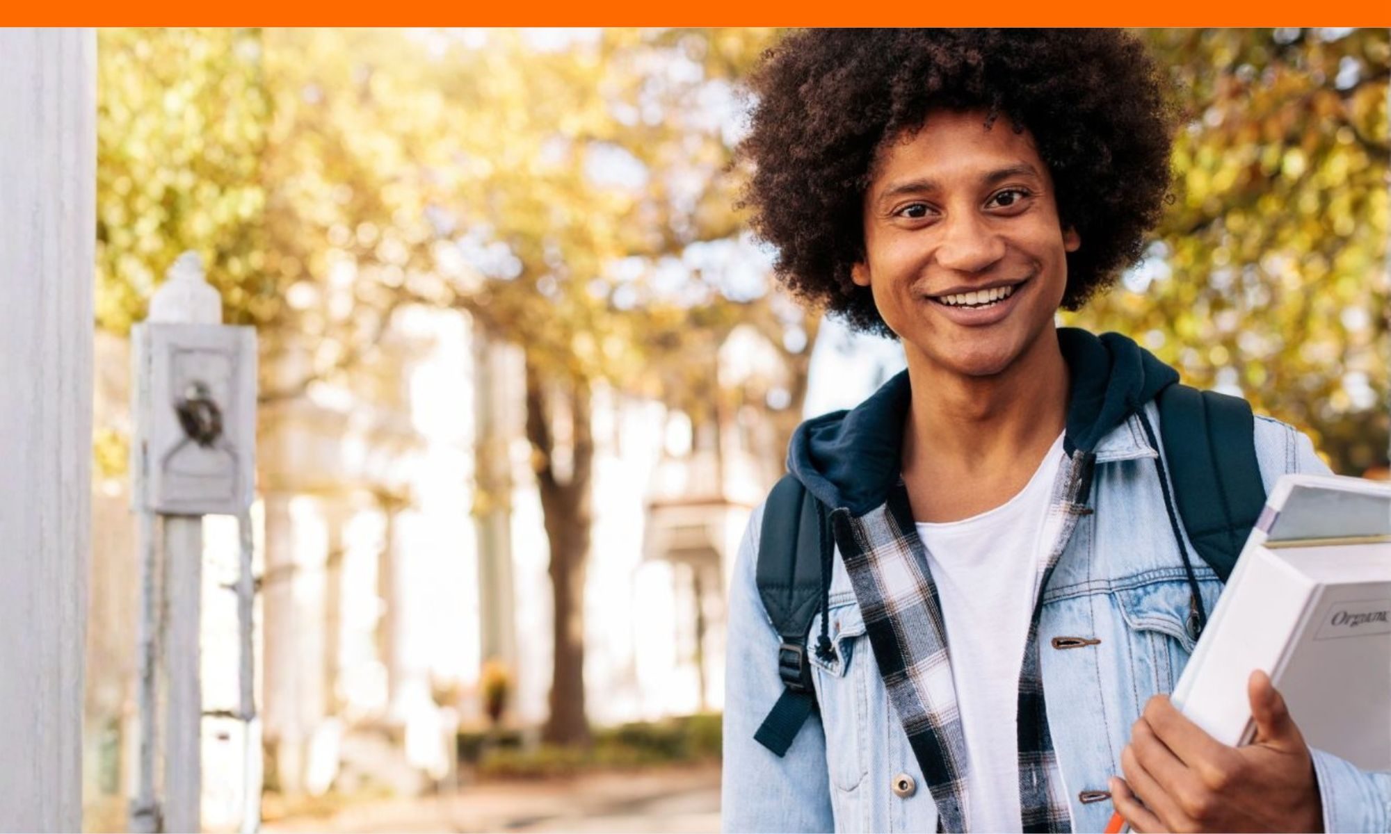 College student carrying books on campus